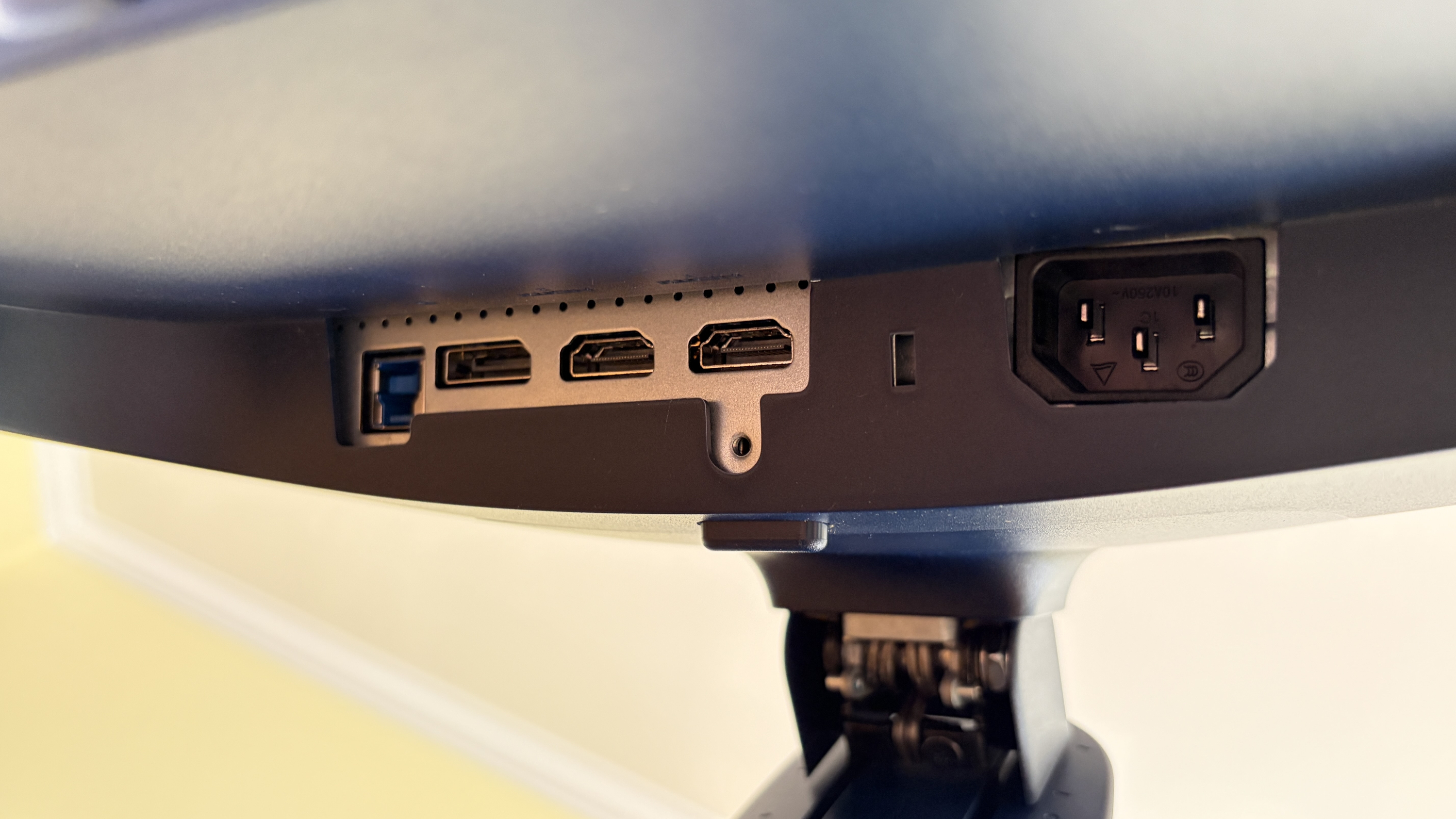 Close-up of a monitor's back panel showing USB, HDMI, and power ports with a sleek black design.