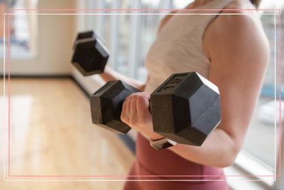 Close up of a woman holding dumbbells 