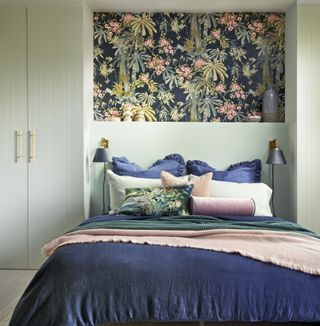 Green bedroom with built-in wardrobes and feature wall