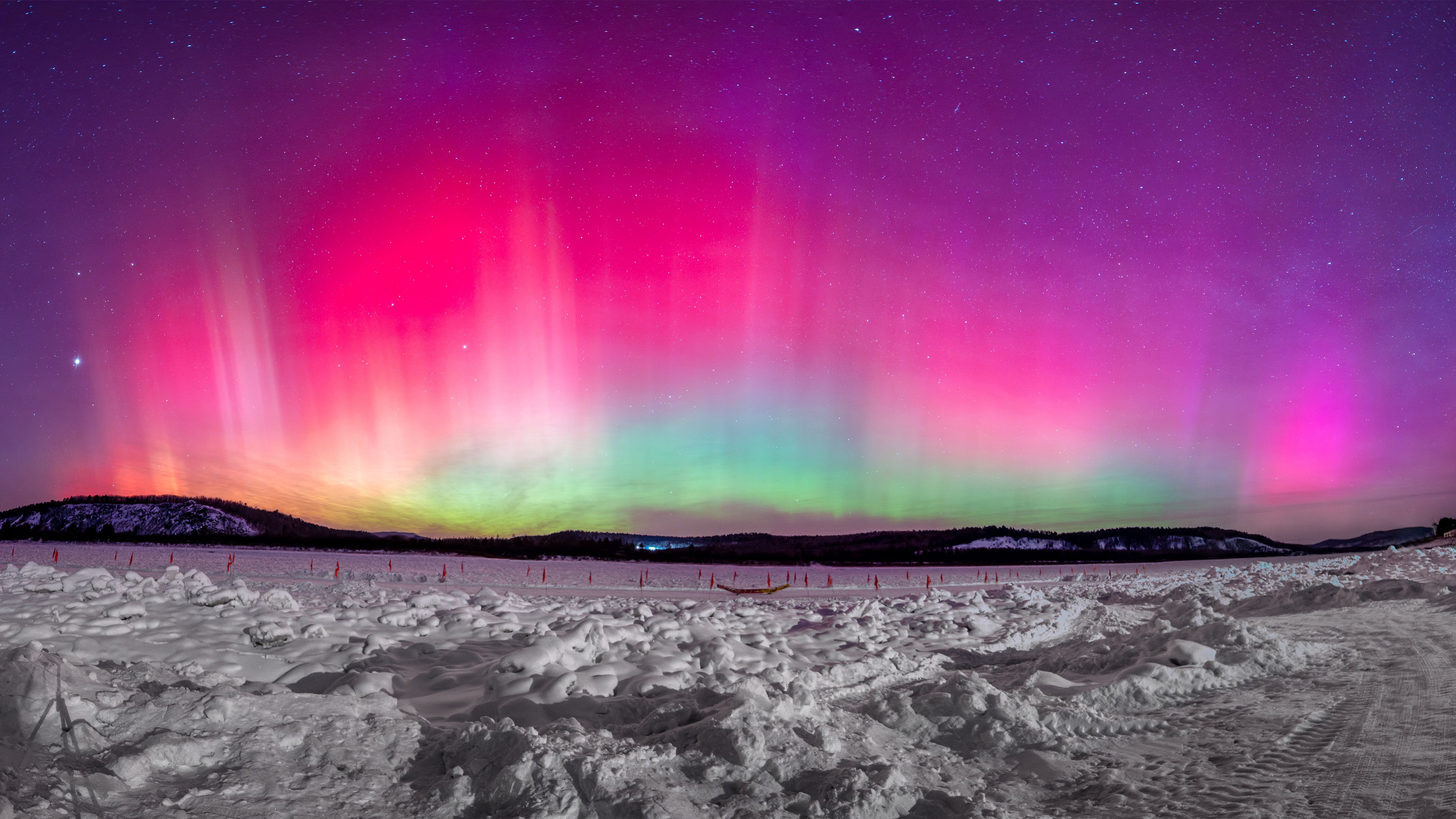 curtain of magenta, green and even blue fills the sky as the northern lights dance above.