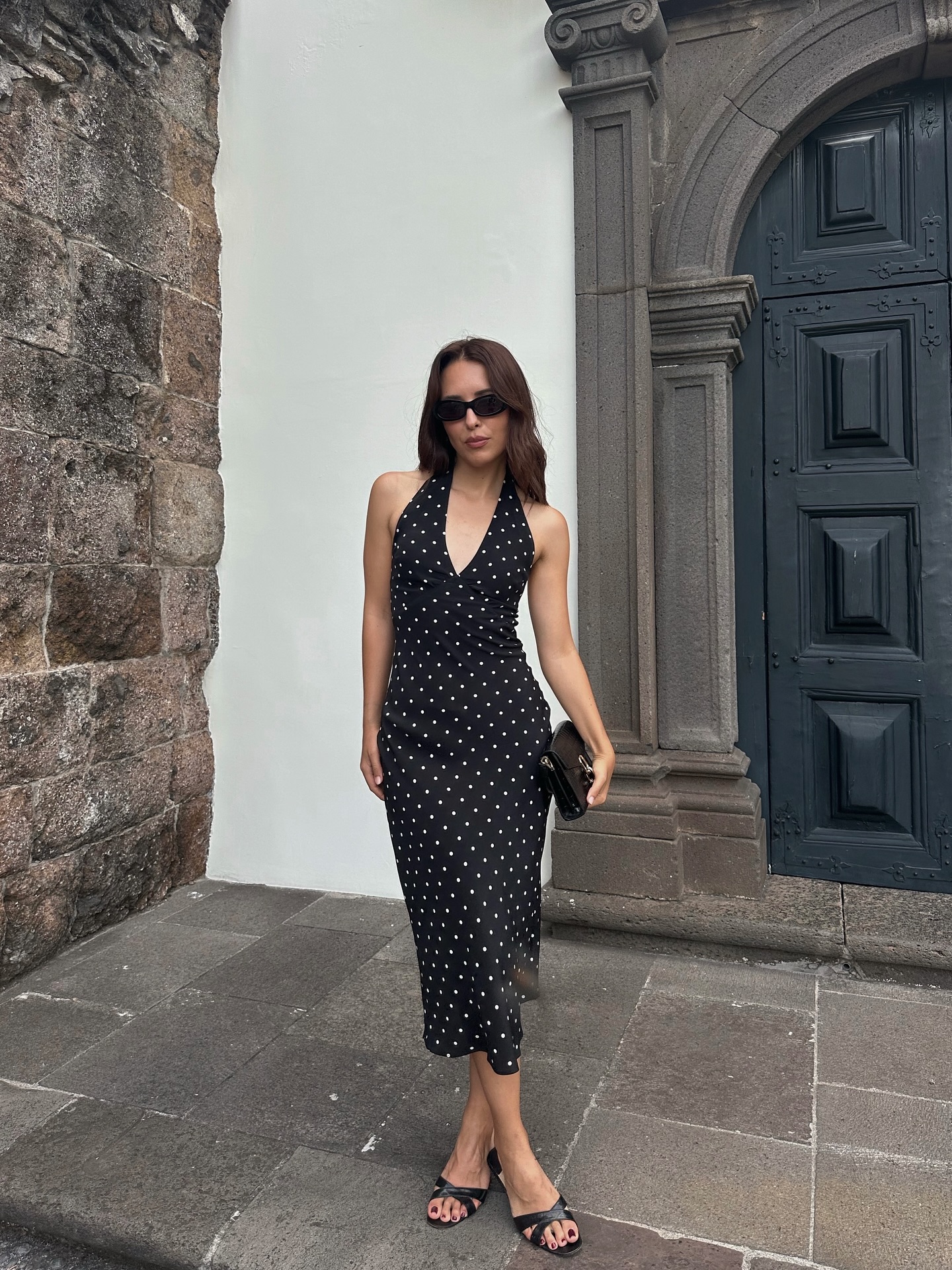 An image of @deborabrosa wearing Manolo Blahnik Callasli heels in black satin with Realisation Par&#039;s black polka dot Sadie dress.