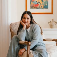 Louise Thompson sitting on a chair in her home