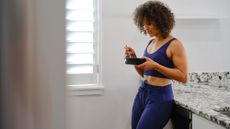 woman eating from a bowl in a matching blue workout set