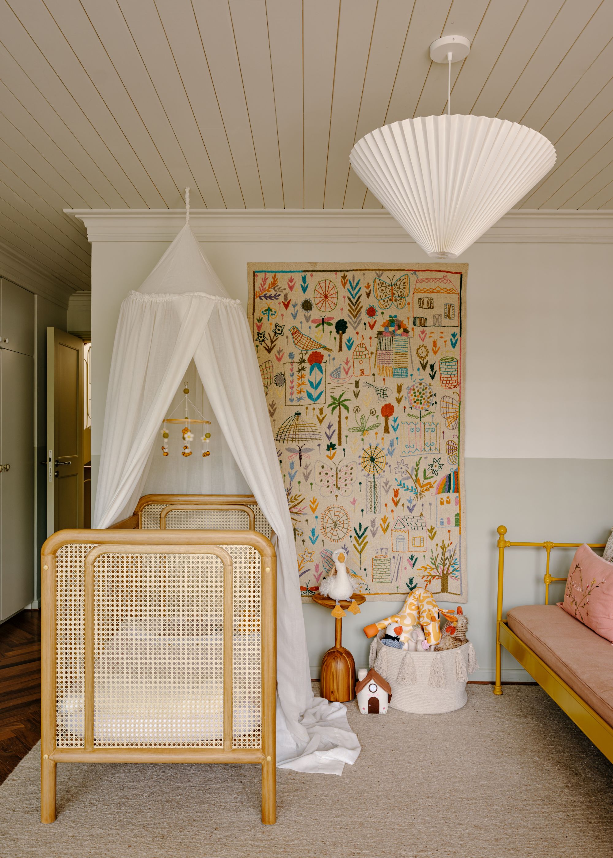 A kids bedroom with a cane and wood cot