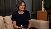 Benson sitting on a couch on Law & Order: SVU.