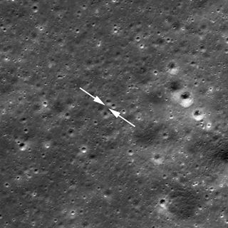 An 80-foot-wide (25 meters) crater in front of the Chang'e 4 lander can be seen in Lunar Reconnaissance Orbiter imagery, just below and to the left of the bottom arrow. The Chang'e 4 lander and rover are not in this photo; it was taken before the duo's historic Jan. 2 touchdown.