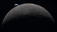 The upper half of the moon, partially lit, with a small crescent-shaped Earth in the background