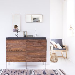 dark wood vanity with grey surface and double sinks and unique rectangular mirrors