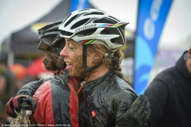 Team RE:CM Davinci's Annika Langvad (right) hugs teammate Ariane Kleinhans after they won stage 5 and extended their women's category lead