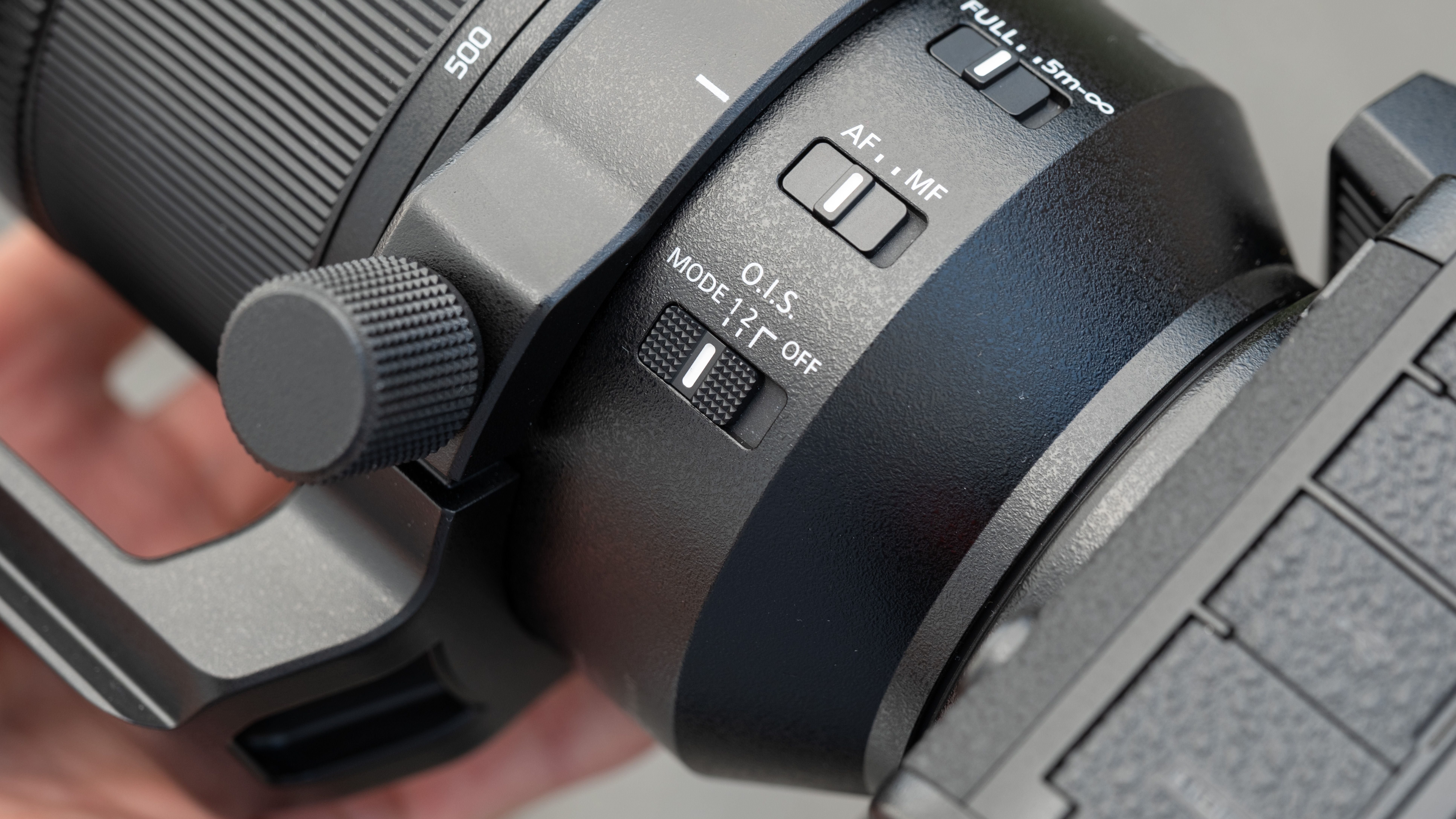Close up of switches on a Lumix S 100-500mm f/5-7.1 lens