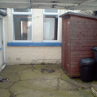 garden area with shed and brick wall