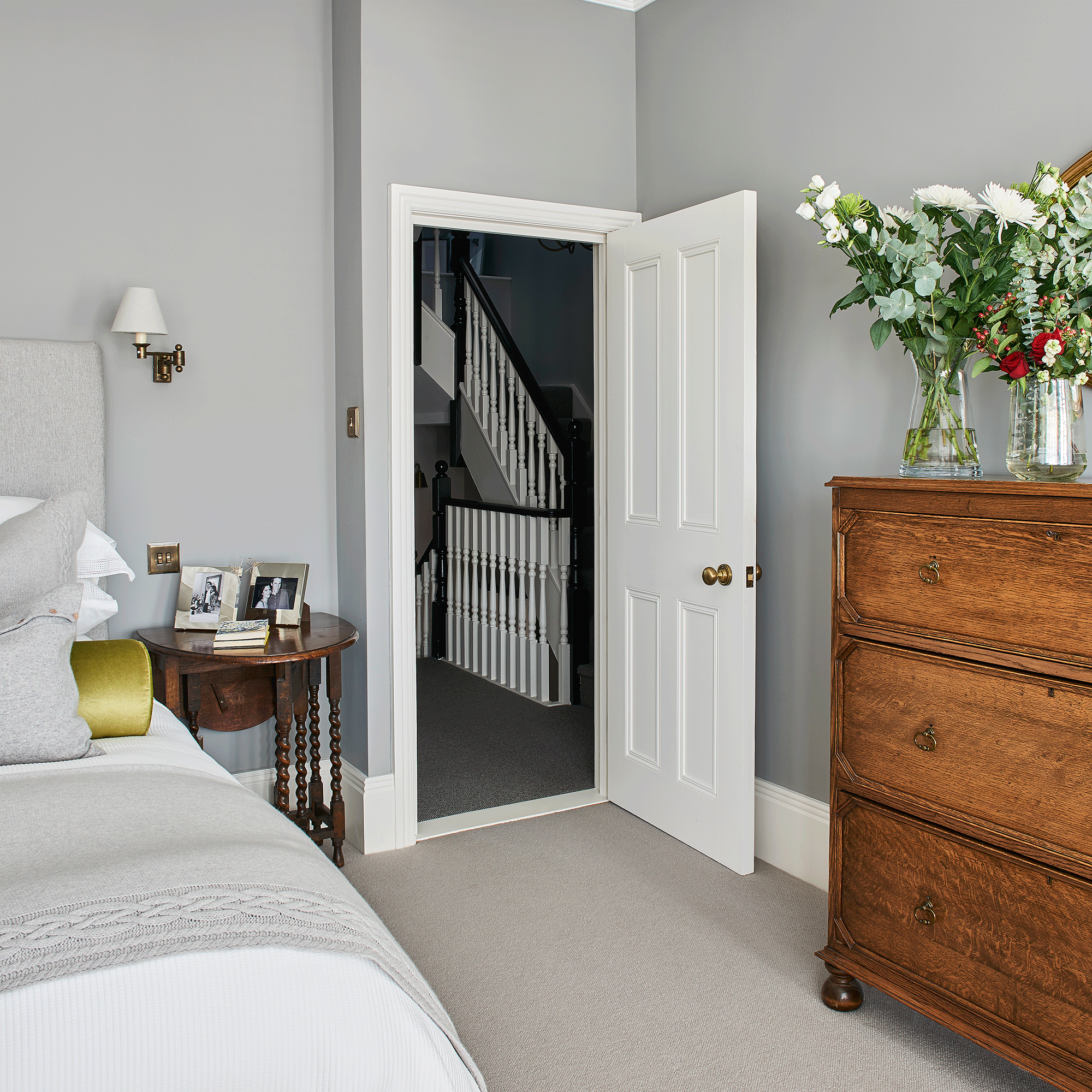 White door leading into a bedroom with grey carpet