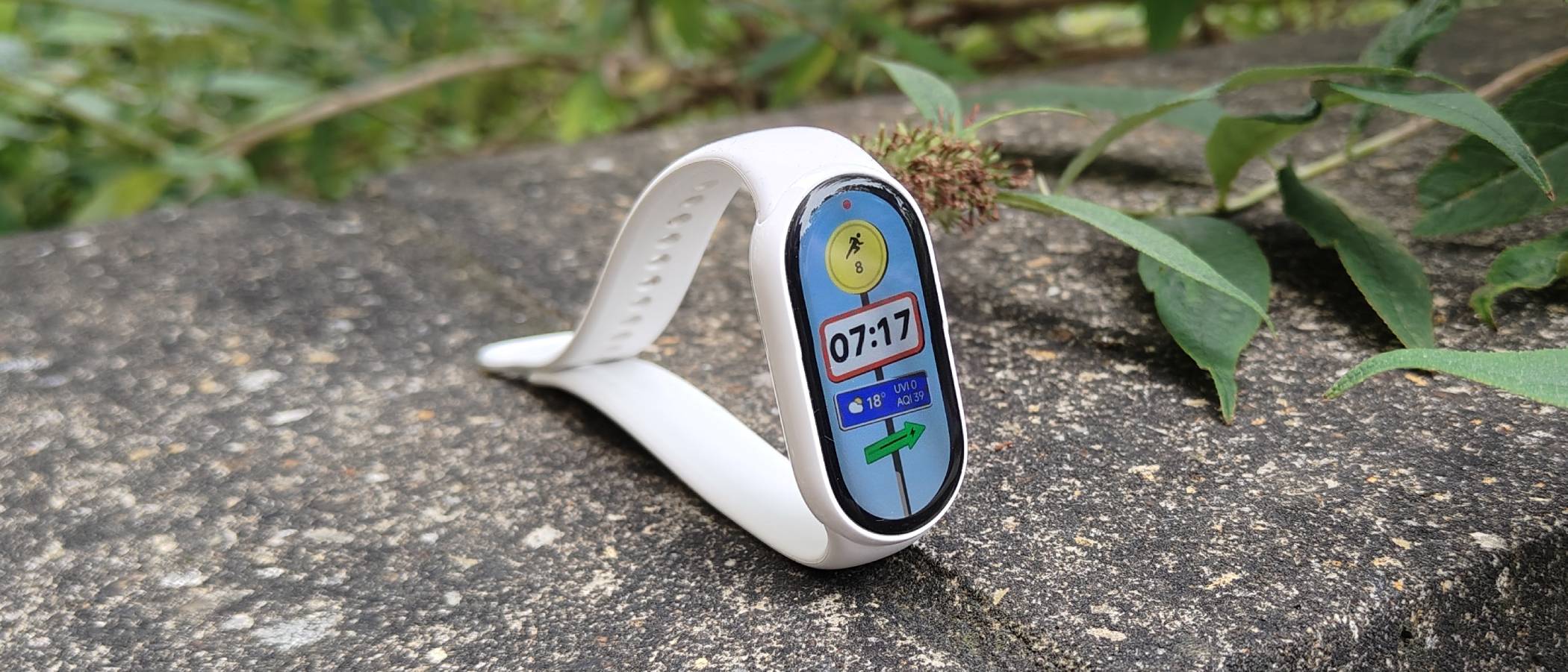 The Xiaomi Smart Band 10 atop a stone wall.