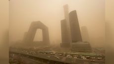 Buildings in the central business district of Beijing start to disappear from view during the sandstorm.