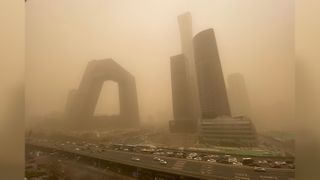 Buildings in the central business district of Beijing start to disappear from view during the sandstorm.