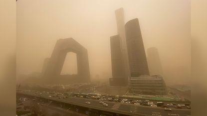 Buildings in the central business district of Beijing start to disappear from view during the sandstorm.