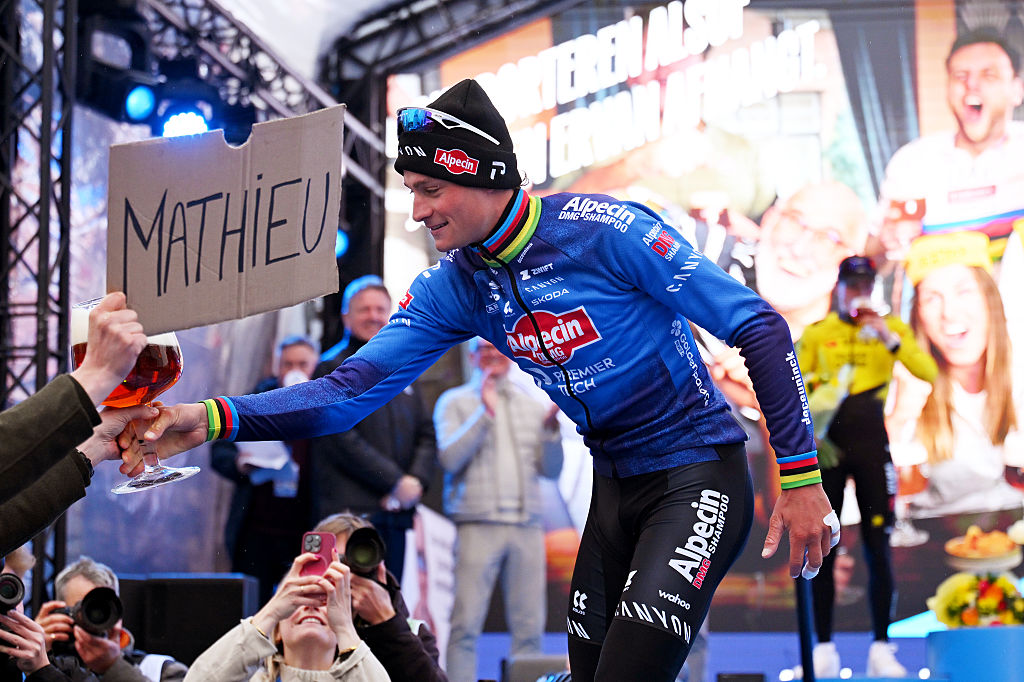 Mathieu van der Poel hands over his podium beer after winning the E3 Saxo Classic