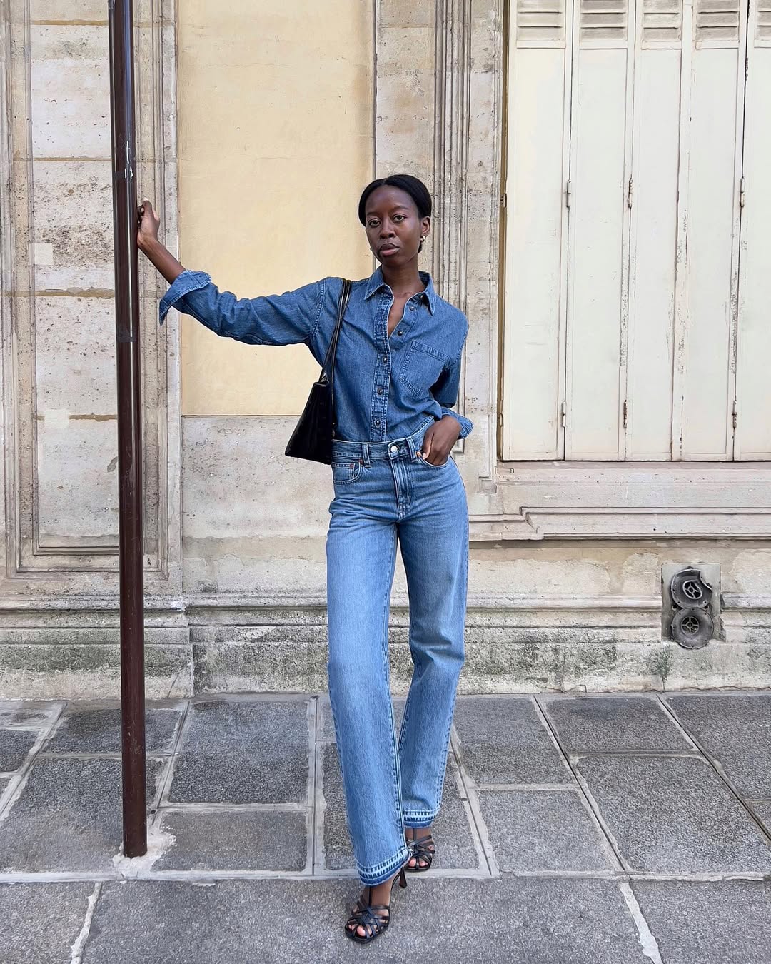 woman wearing slim jeans and denim button-down shirt