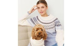 best Christmas jumpers illustrated by a woman and a dog wearing matching blue and cream fair isle jumpers