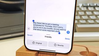 Apple Intelligence Writing Tools rewriting a text message about an upcoming meeting in "Friendly" style in iOS 18.1