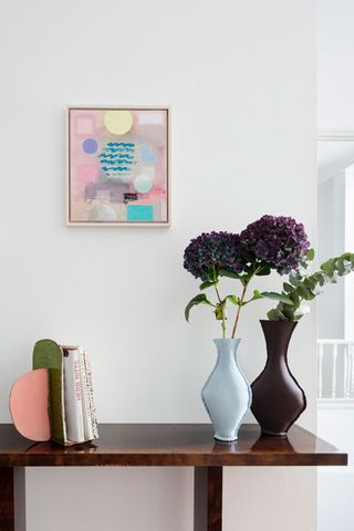 canopy-collection-wooden-console-table-colourful-vases-with-bright-wall-art