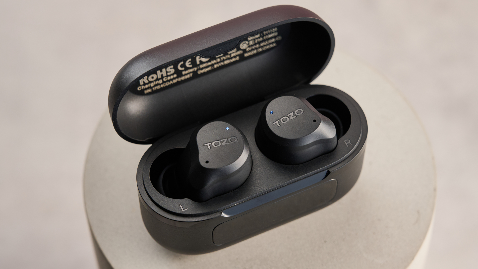 Tozo NC9 earbuds inside charging case