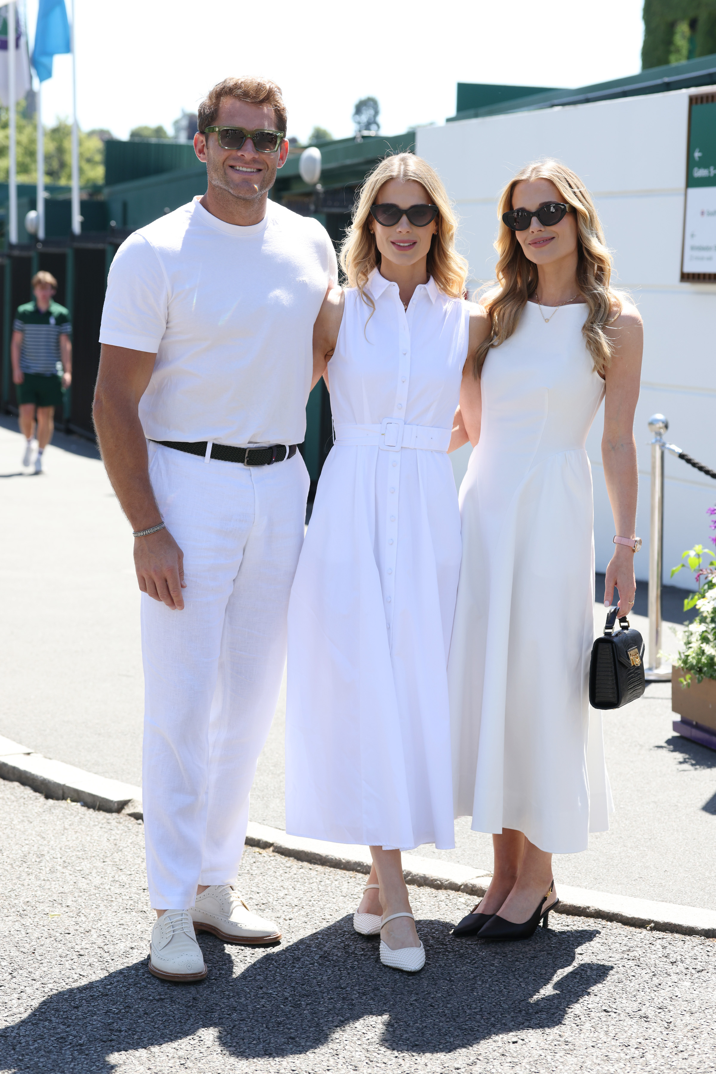 Greg Mallett, Amelia Spencer and Eliza Spencer pose in white outfits at Wimbledon 2026