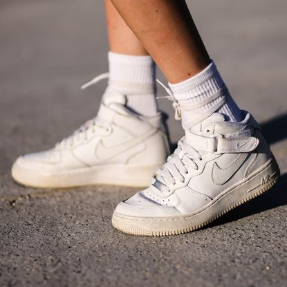 Emy venturini wears white ribbed Calzedonia socks, white shiny leather Court Borough Mid 2 sneakers from Nike, on August 25, 2021 in Paris, France