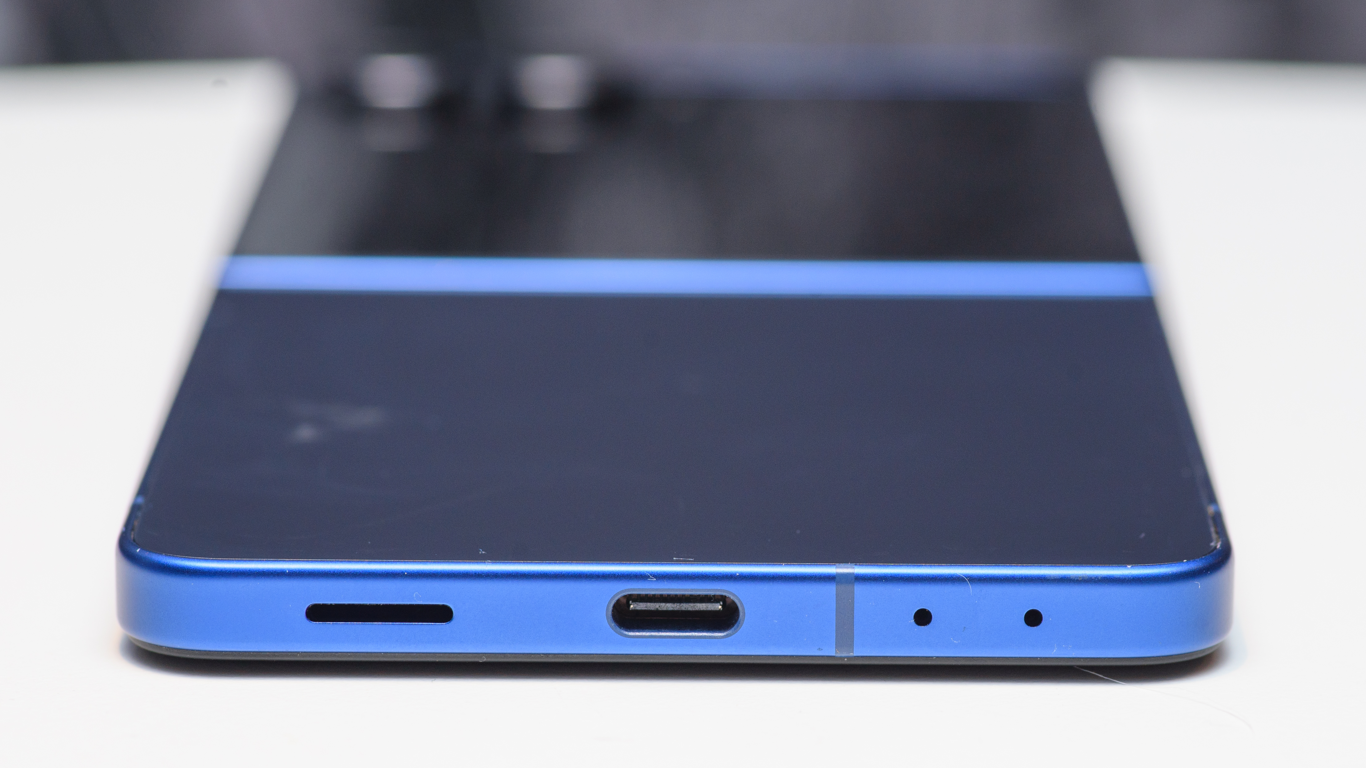 Samsung Galaxy Z Flip 7 in blue lying flat facing the USB-C port on the bottom