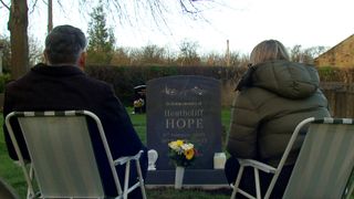 Cathy and Bob look at Heath's headstone