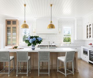 kitchen with white cabinets and island with white counter top