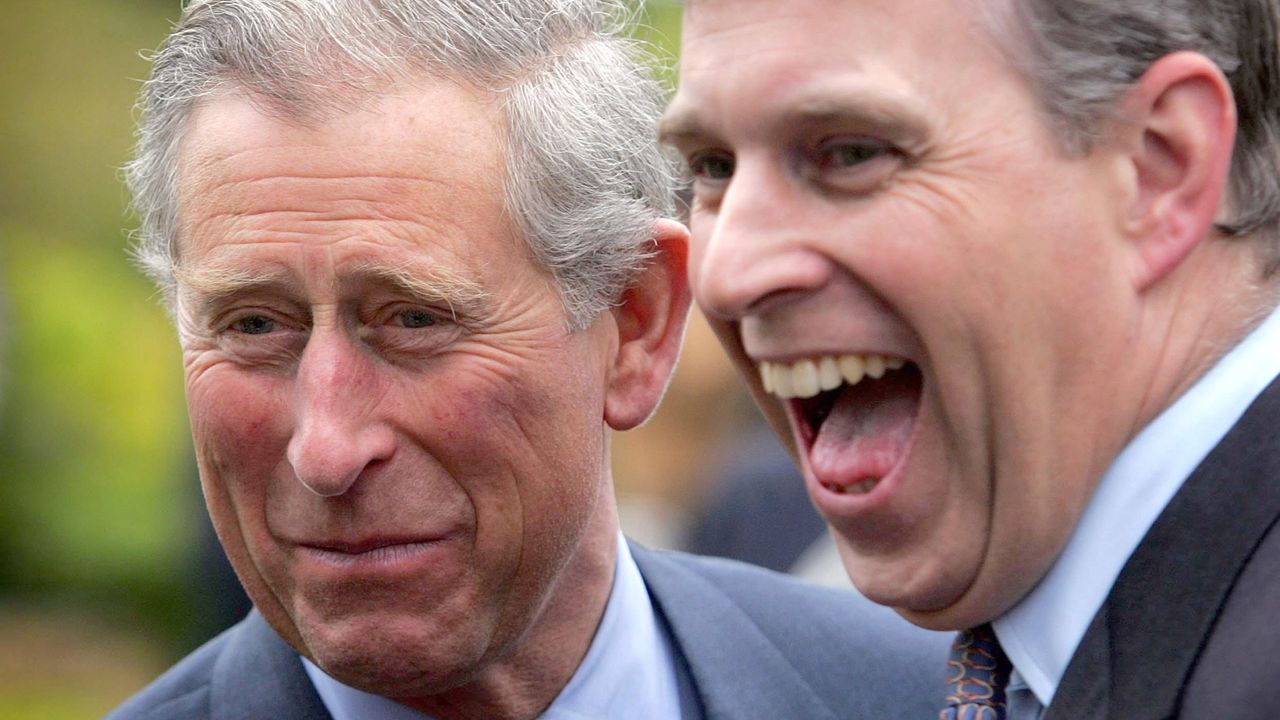 King Charles and Prince Andrew both laugh while wearing suits