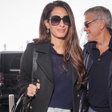 Amal Clooney was spotted at the Milan airport in the baggy, straight-leg jeans trend