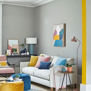 grey living room with white sofa and cushions