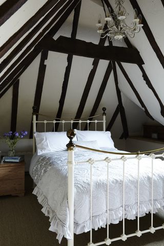 Beamed bedroom in the Bunyans' Grade II listed 16th century former coaching inn from Period Living magazine