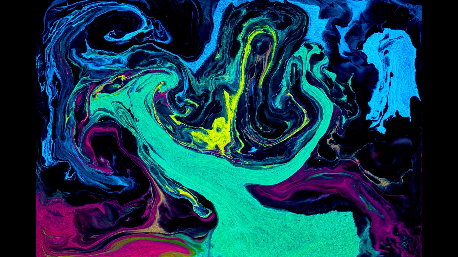Colored paints swirling about, shot from above