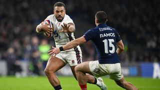 Ollie Lawrence of England makes a break past Thomas Ramos of France to score his team's first try during the Guinness Six Nations 2025 match between England and France at Allianz Stadium on February 08, 2025 in London, England. 