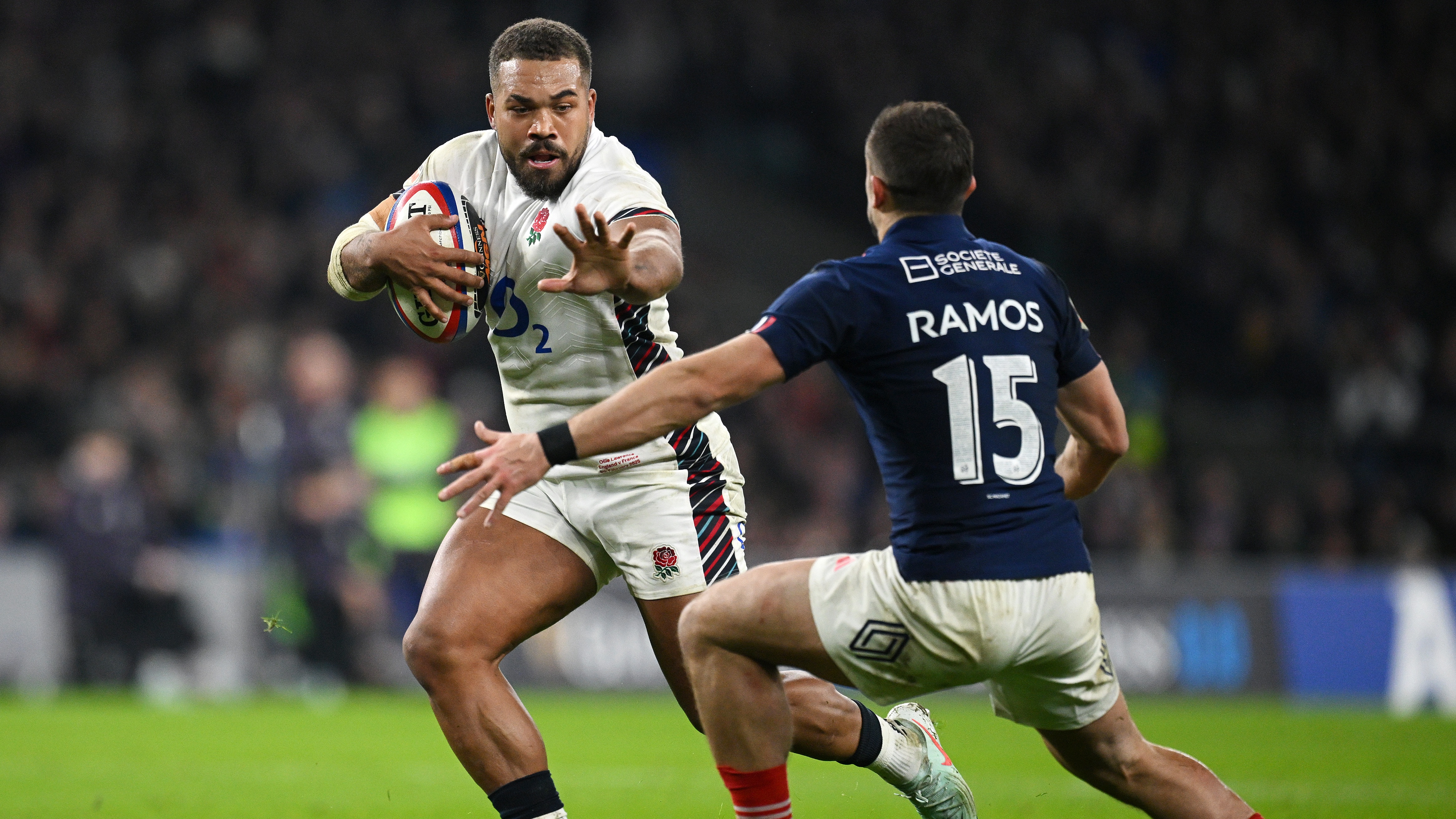 Ollie Lawrence of England makes a break past Thomas Ramos of France to score his team's first try during the Guinness Six Nations 2025 match between England and France at Allianz Stadium on February 08, 2025 in London, England. 