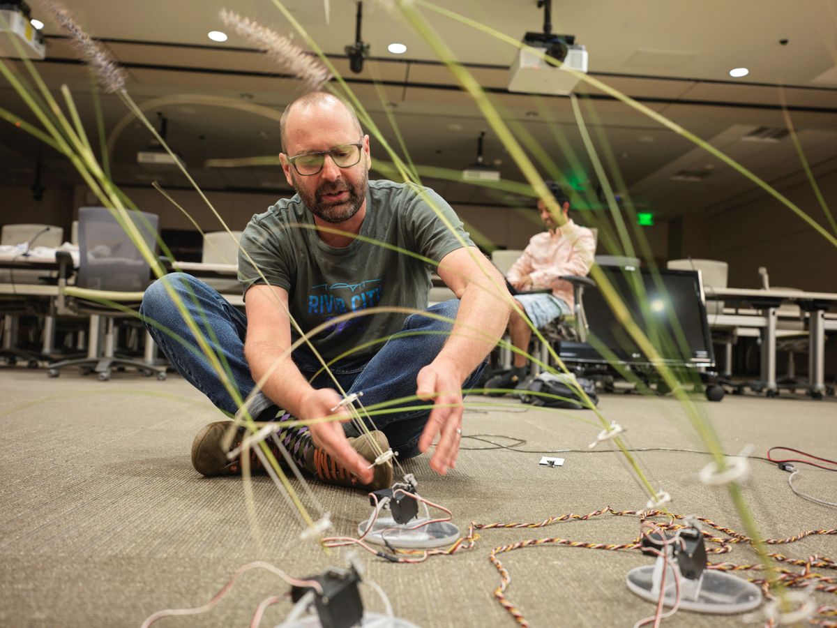 Artist david bowen working on the grass stalks for NASA's PST: Art and Science Collide exhibit.