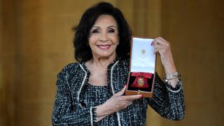 Shirley Bassey poses after being made a Companion of Honour during an investiture ceremony at Windsor Castle