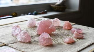 Rose quartz crystals on a spiritual cloth to show how to use crystals in the home for protection