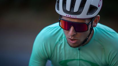 Oakley Sutro review: Pictured here. a cyclist wearing a helmet and the Oakley sunglasses