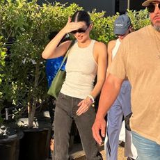 Kendall Jenner wears silver trainers.