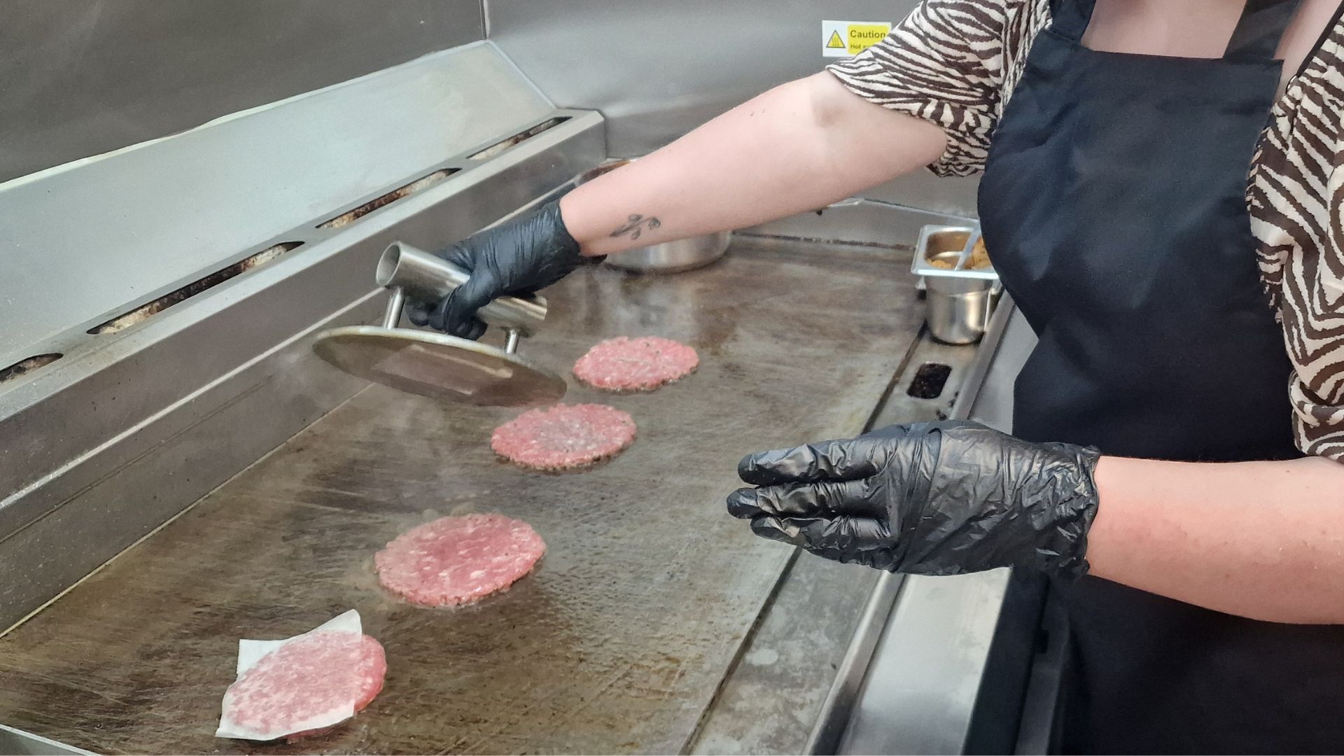 Smashing burgers on the griddle