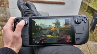 The Steam Deck playing Cyberpunk 2077, outside in a much-too-small back garden