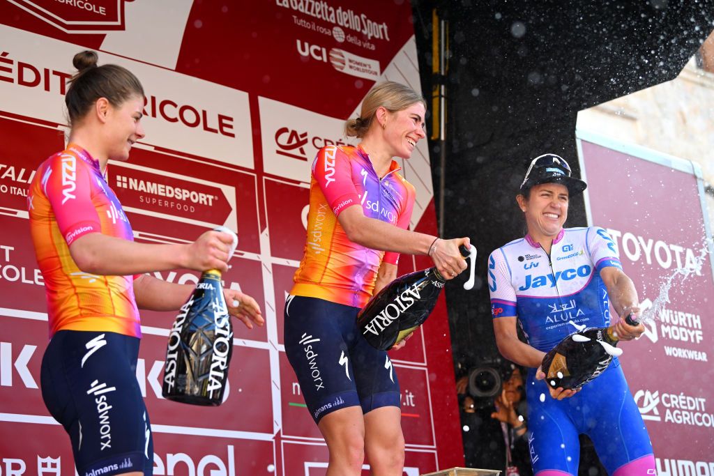 SIENA ITALY MARCH 04 LR Lotte Kopecky of Belgium and Team SD Worx on second place race winner Demi Vollering of The Netherlands and Team SD Worx and Kristen Faulkner of The United States and Team JaycoAlula on third place celebrate on the podium ceremony after the Eroica 9th Strade Bianche 2023 Womens a 136km one day race from Siena to Siena 318m StradeBianche on March 04 2023 in Siena Italy Photo by Luc ClaessenGetty Images