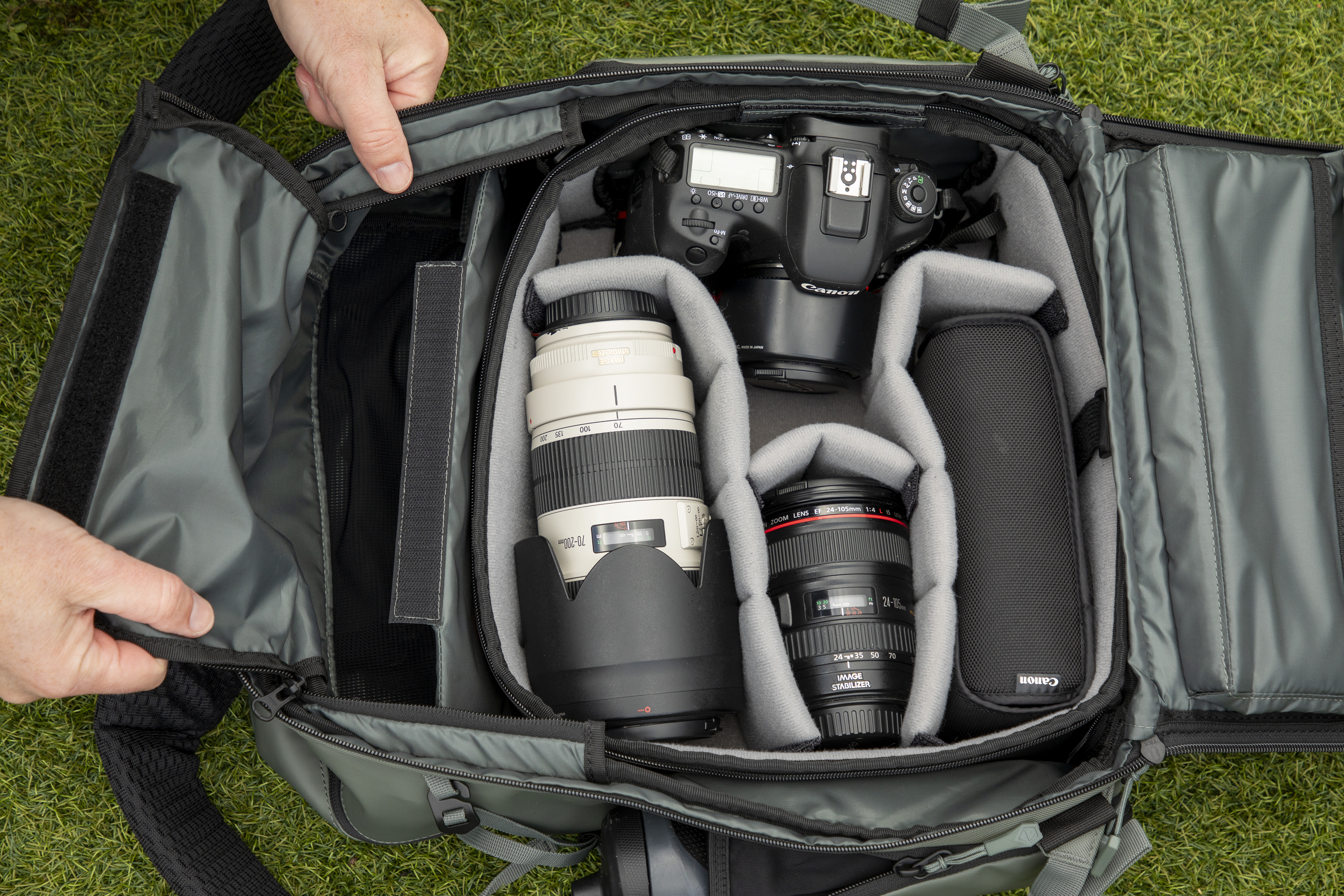 inside a camera backpack with internal dividers, being removed