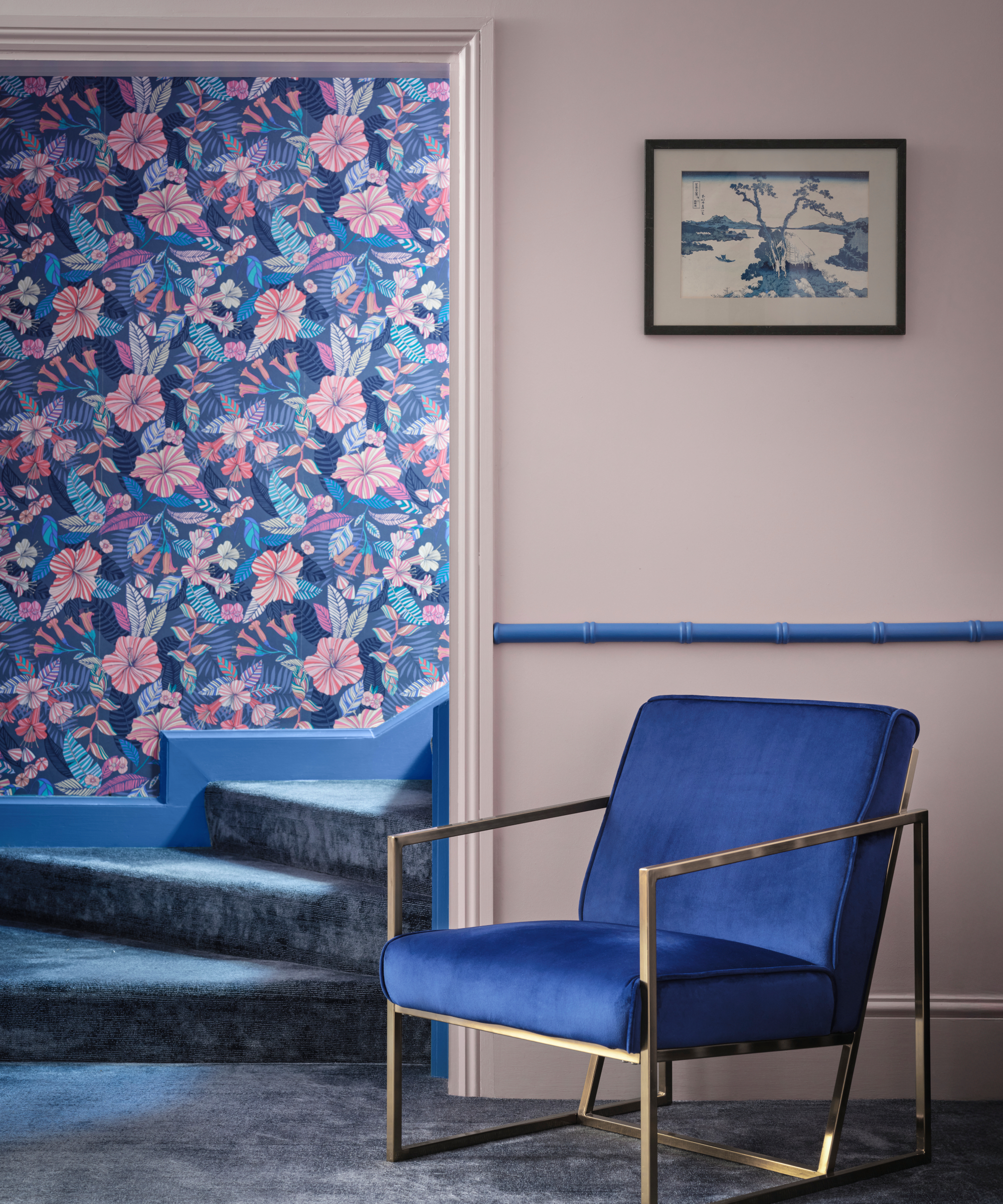 room with pale pink walls and woodwork, blue dado rail, blue and pink wallpaper, blue carpet and blue chair with metal gold framework