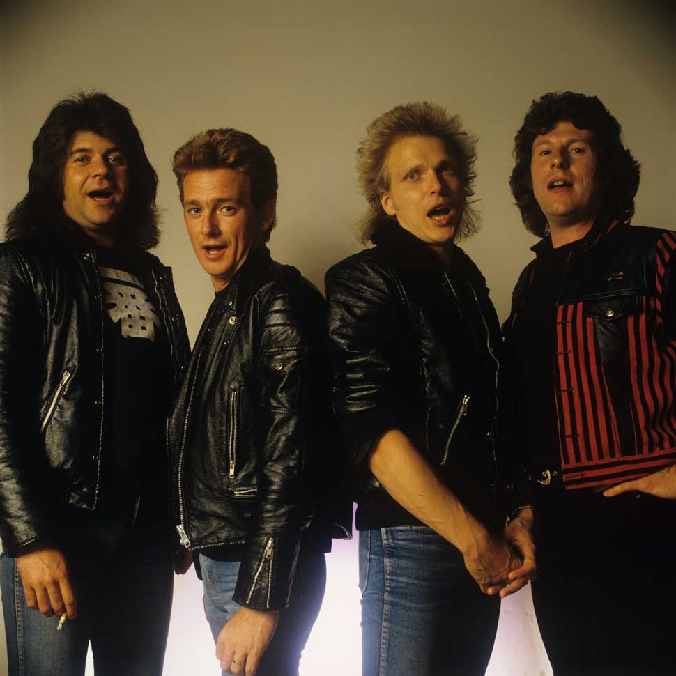 Posed group portrait of the Michael Schenker Group. Left to right are Chris Glen, Graham Bonnet, Michael Schenker and Ted McKenna in 1982.