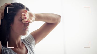 Woman experiencing tiredness, one of the symptoms of shingles